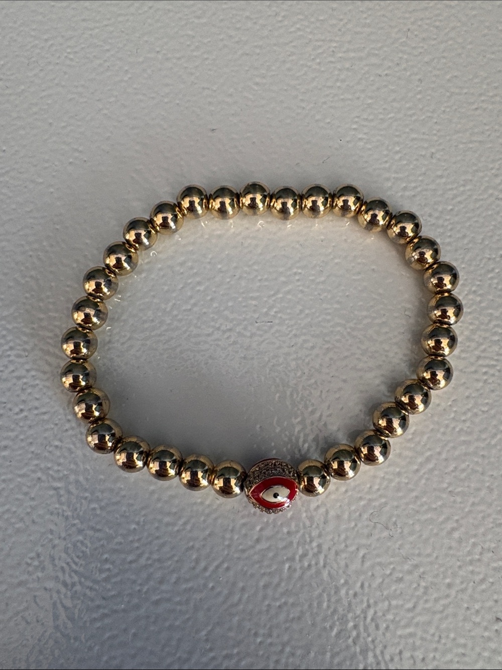Gold filled Beaded Bracelet with Red Eye Charm